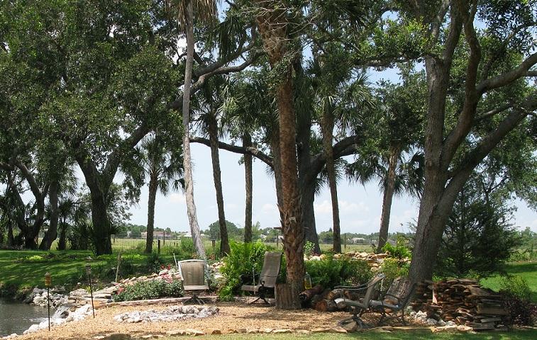 Outdoor seating area with fire pit and water features.